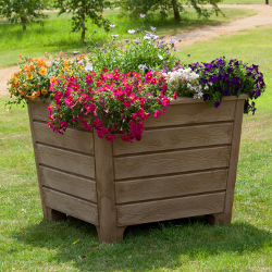 Newforest planter outside in the sunshine with flowers